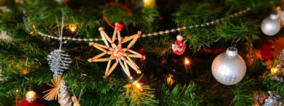 Close-up of a decorated Christmas tree with lights and ornaments, showcasing holiday spirit.